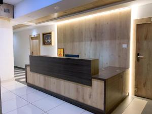 a lobby with a reception desk in a building at New Thai Residency in Dhārāpuram