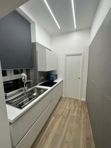 a kitchen with a sink and a counter top at Napoli centro - Di&da guest house in Naples +23 photos
