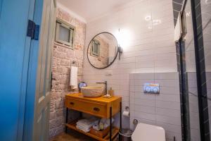 a bathroom with a sink and a mirror at Cundalis1893 in Ayvalık