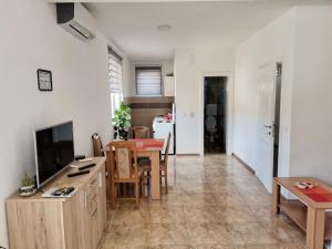 a living room with a table and a dining room at Apartman Poljčić Višegrad in Višegrad