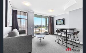 a living room with a couch and a table at MetaWise Sydney CBD Haymarket 2Bed Apartment 1506 in Sydney