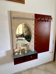 a bathroom with a mirror on a wall at Katerina's Rest Stone Ηouse in Khárakas