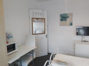 a small kitchen with a table and a microwave at Fresher Space Home Stay in Birmingham