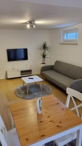 a living room with a couch and a coffee table at Unterkunft Sanic in Kronberg im Taunus