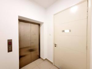 a door in a room with a corridor at Arte Plus By Sleepy Bear in Batu Empat
