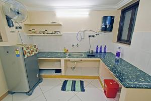 a kitchen with a sink and a refrigerator at galaxy inn Home stay-white town in Puducherry +17 photos