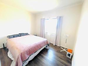 a bedroom with a bed and a large window at Ross Creek farm Stay 