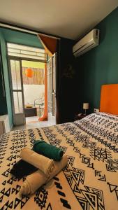 a bedroom with a bed with a pattern on it at La Pita Beach house in Almería