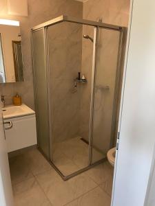 a shower with a glass door in a bathroom at goodstay in Winterthur