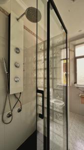 a glass shower door in a bathroom with a sink at La Pita Beach house in Almería +124 photos