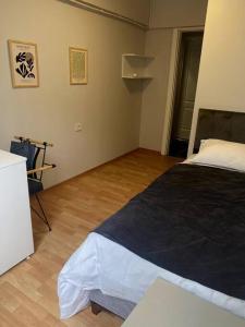 a bedroom with a bed and a wooden floor at Fresh room with a balcony in a digital nomad house in Istanbul