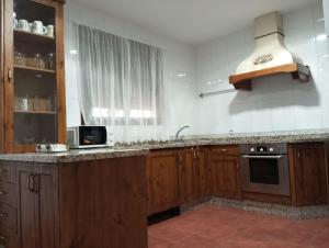 a kitchen with a sink and a counter top at VILLA BILBILIS con piscina privada, barbacoa y parking in Linares