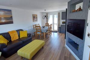 a living room with a couch and a fireplace at High Tide in Braunton