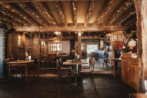 a dining room with wooden tables and chairs at The Ship Inn in Rye