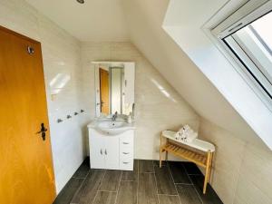 a white bathroom with a sink and a shower at Ruhe und Natur pur im Spreewald. in Kolkwitz +6 photos