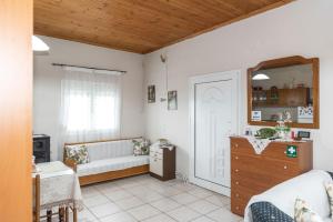 a living room with a couch and a mirror at Cottage Lina in Edessa +35 photos