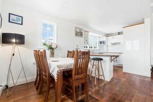 a kitchen with a table and chairs in a room at Albert.T Home in Auckland