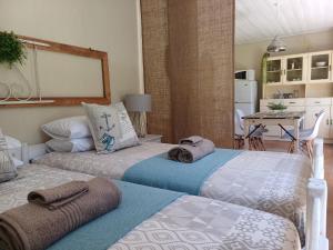 two beds sitting next to each other in a room at Booiskraal Farm Stay Accommodation in Beaufort West