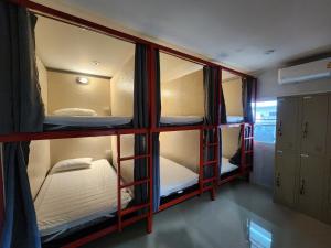 a room with three bunk beds in a room at No.9 Hostel kanchanaburi in Ban Don Rak