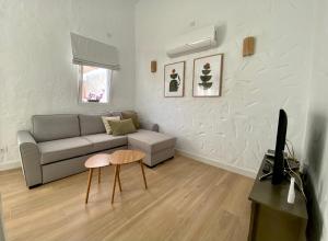 a living room with a couch and a table at Renovated nice private bungalow in Playa del Ingles