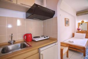 a small kitchen with a sink and a stove at Pansion Prodromina in Skopelos Town