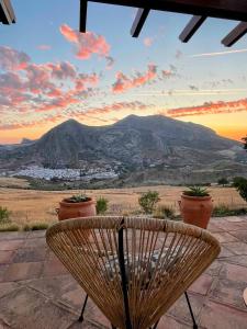 a bench sitting in front of a view of a mountain at La Sorpresa in Valle de Abdalagís