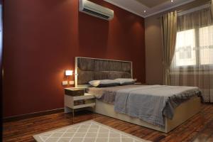a bedroom with a large bed and a window at Luxurious apartment - New Cairo in Cairo