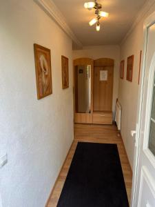 a hallway with a black rug on the floor at Ruhige geräumige Wohnung in Pforzheim