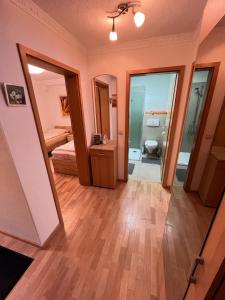 a room with a bedroom and a bathroom with a toilet at Ruhige geräumige Wohnung in Pforzheim