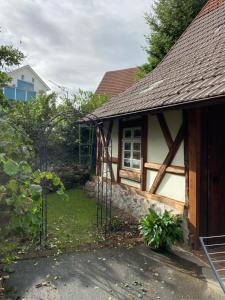 a small house with a gate in the yard at Basler Ferienwohnung in Offenburg
