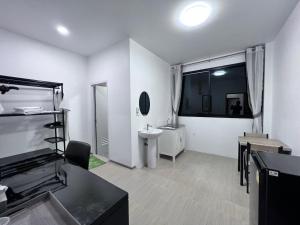 a white bathroom with a sink and a mirror at Hori hotel in Ban Nong Khaman