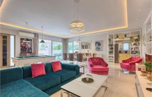 a living room with a blue couch and pink chairs at Villa Dream House in Pula +52 photos