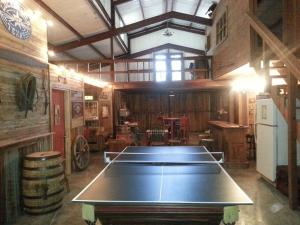 a ping pong table in the middle of a room at Waterfront Ranch Home + Bunk Barn + Guest Cabin in Alba
