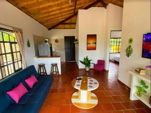 a living room with a blue couch and a table at Casas De Campo - El Paraíso in La Vega