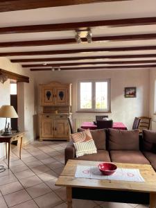 a living room with a couch and a table at Gite Du Rittersberg in Scherwiller