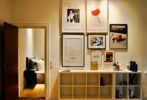 a room with a shelf and pictures on the wall at Aparthotel Mageløs 12 in Odense