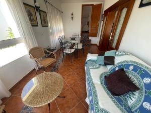 a living room with a couch and a table at ESTEPONA BEACH SUITES 3. URB. ARENA BEACH 9 in Estepona