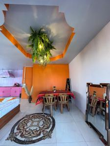 a dining room with a table and a ceiling at Heaven Guesthouse in Pakse