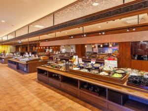 a restaurant with a buffet line of food at Yukai Resort Unzen Toyokan in Obama