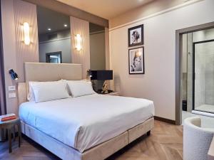Postel nebo postele na pokoji v ubytování The Glam Boutique Hotel & Apt
