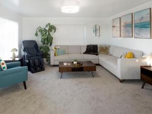 a living room with a couch and a table at Quaint Mid-Century Cottage by the Coast in Ventura