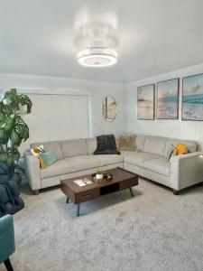 a living room with a couch and a coffee table at Quaint Mid-Century Cottage by the Coast in Ventura