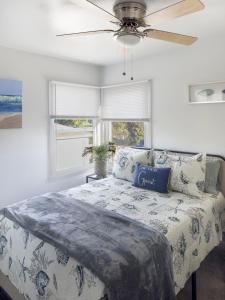 a bedroom with a bed with a ceiling fan at Quaint Mid-Century Cottage by the Coast in Ventura