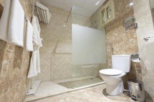 a bathroom with a toilet and a shower at Al Joud Boutique Hotel, Makkah in Mecca