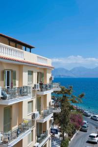 a building with balconies and the ocean in the background at Mare Hotel Apartments in Agios Nikolaos