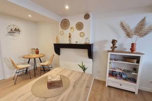 a living room with a table and a fireplace at L'échappée Belle in Vienne