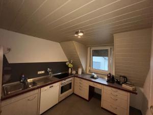a small kitchen with a sink and a stove at DEA Ferienwohnung in Korb