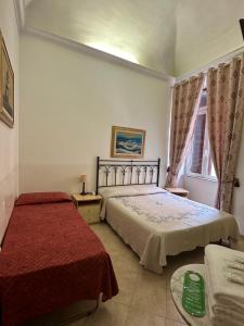 Postel nebo postele na pokoji v ubytování Alloggio Turistico + 3 fotografie