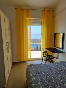 a bedroom with a bed and a desk and a window at Apartman Rene, 150m from the sea, panorama view, Crikvenica, Dramalj, parking in Dramalj