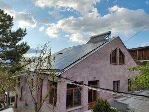 a house with a solar roof on top of it at Mashtots B&B in Vanadzor